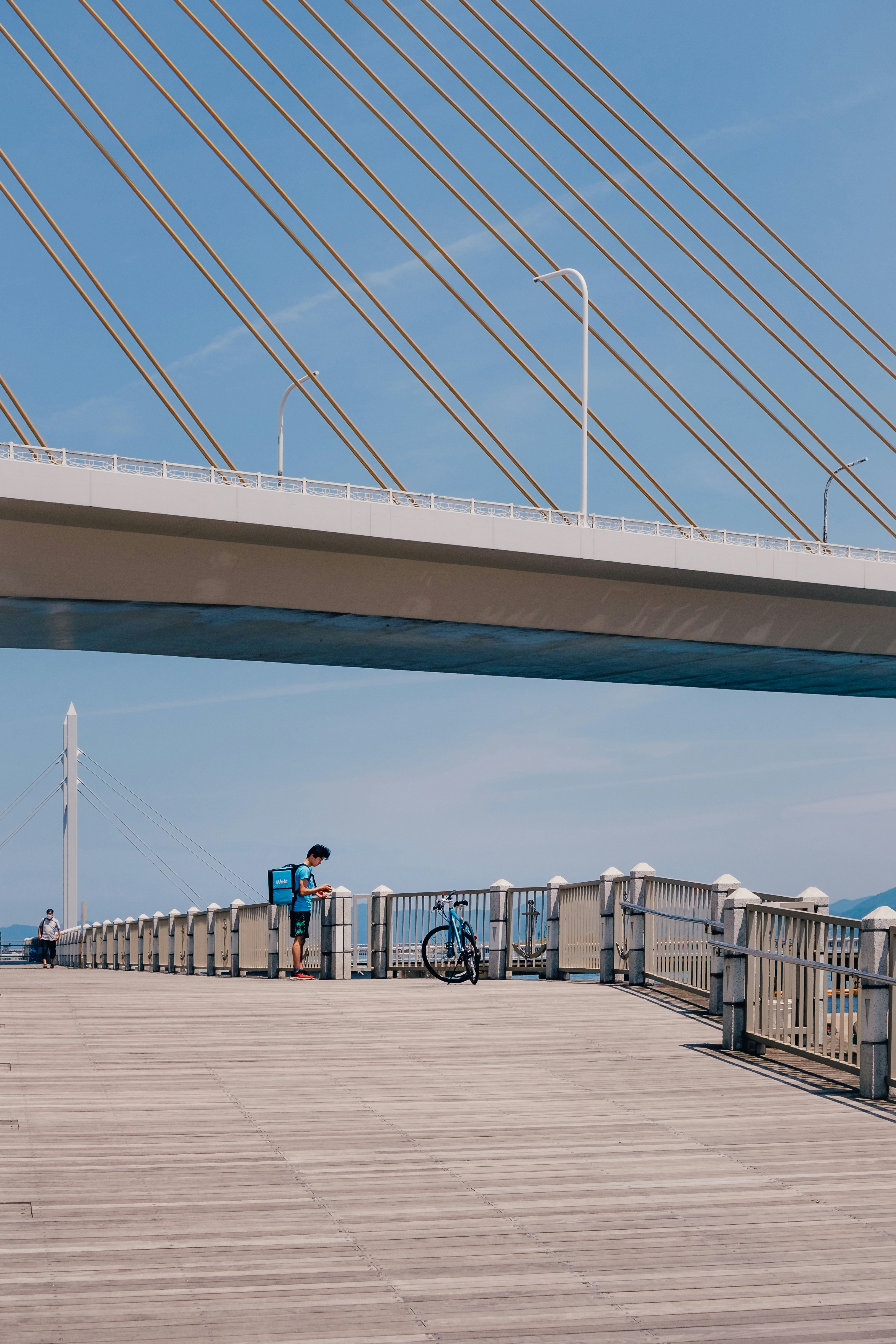 people walking on wooden bridge during daytime